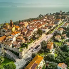 Vista aerea di Castiglione del Lago, un borgo medievale con tetti arancioni affacciato sul lago Trasimeno.