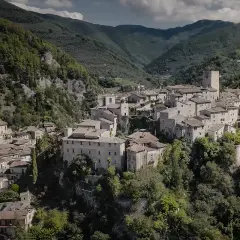 Borgo medievale di Arrone, Terni, incastonato tra verdi colline. Case in pietra e un'antica torre dominano il paesaggio.