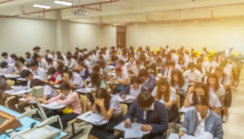 Aula universitaria affollata, studenti concentrati sugli esami. Il sfp significato università è la chiave per il loro futuro.