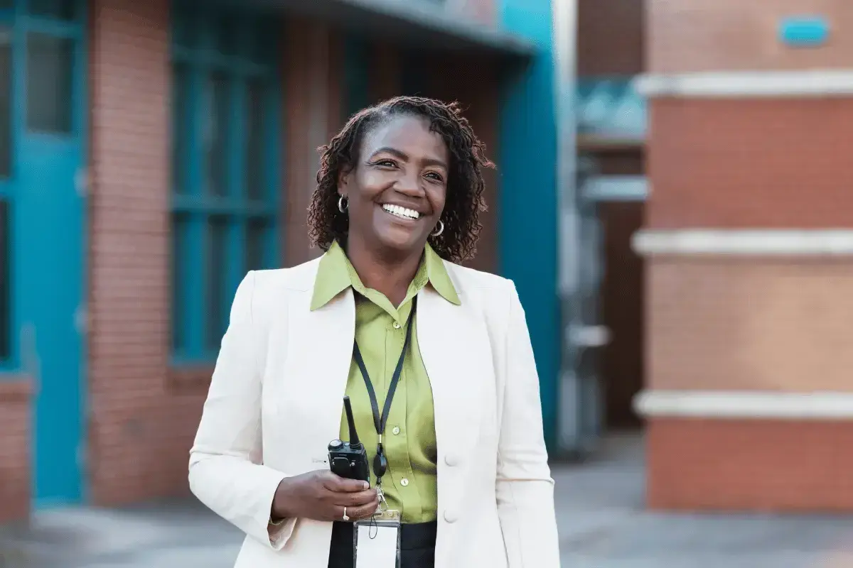 Donna sorridente con un walkie-talkie, pronta per il suo lavoro. Il suo dsga stipendio è meritato.